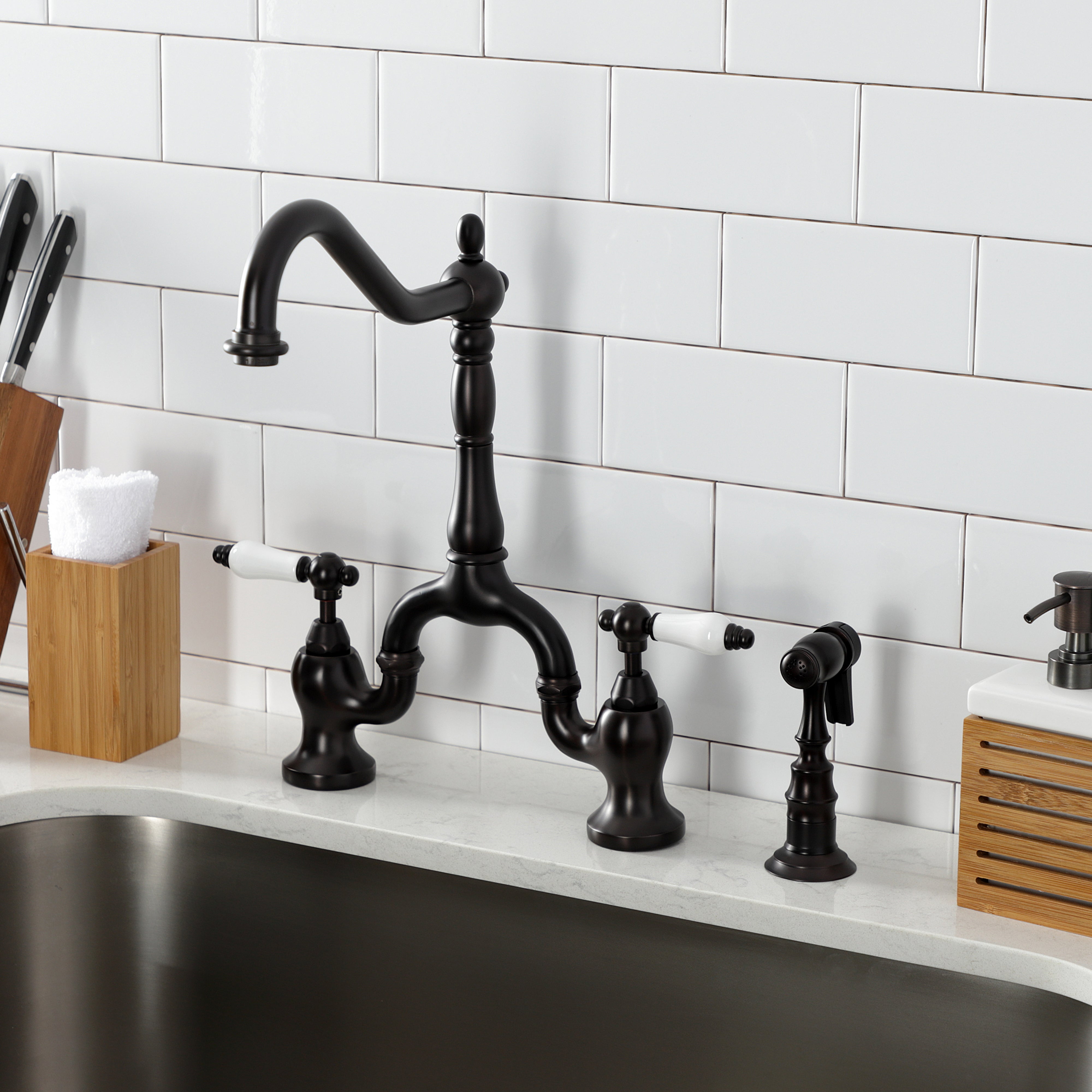 Kingston KS7753PLBS English Country Bridge Kitchen Faucet with Brass Sprayer, Antique Brass installed in kitchen setting