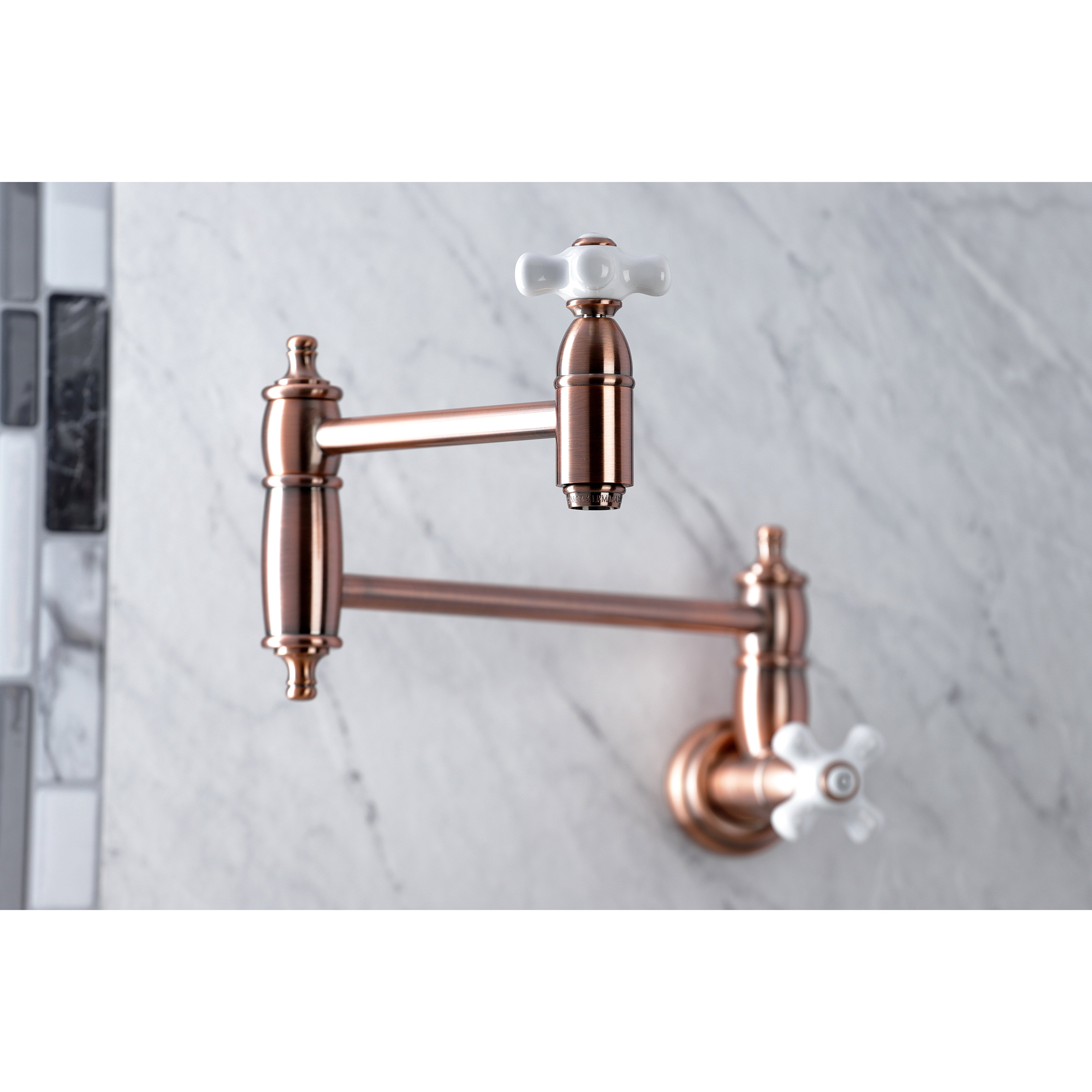 Kingston Brass KS310PXAC Restoration Wall Mount Pot Filler Faucet, Antique Copper on marble background.
