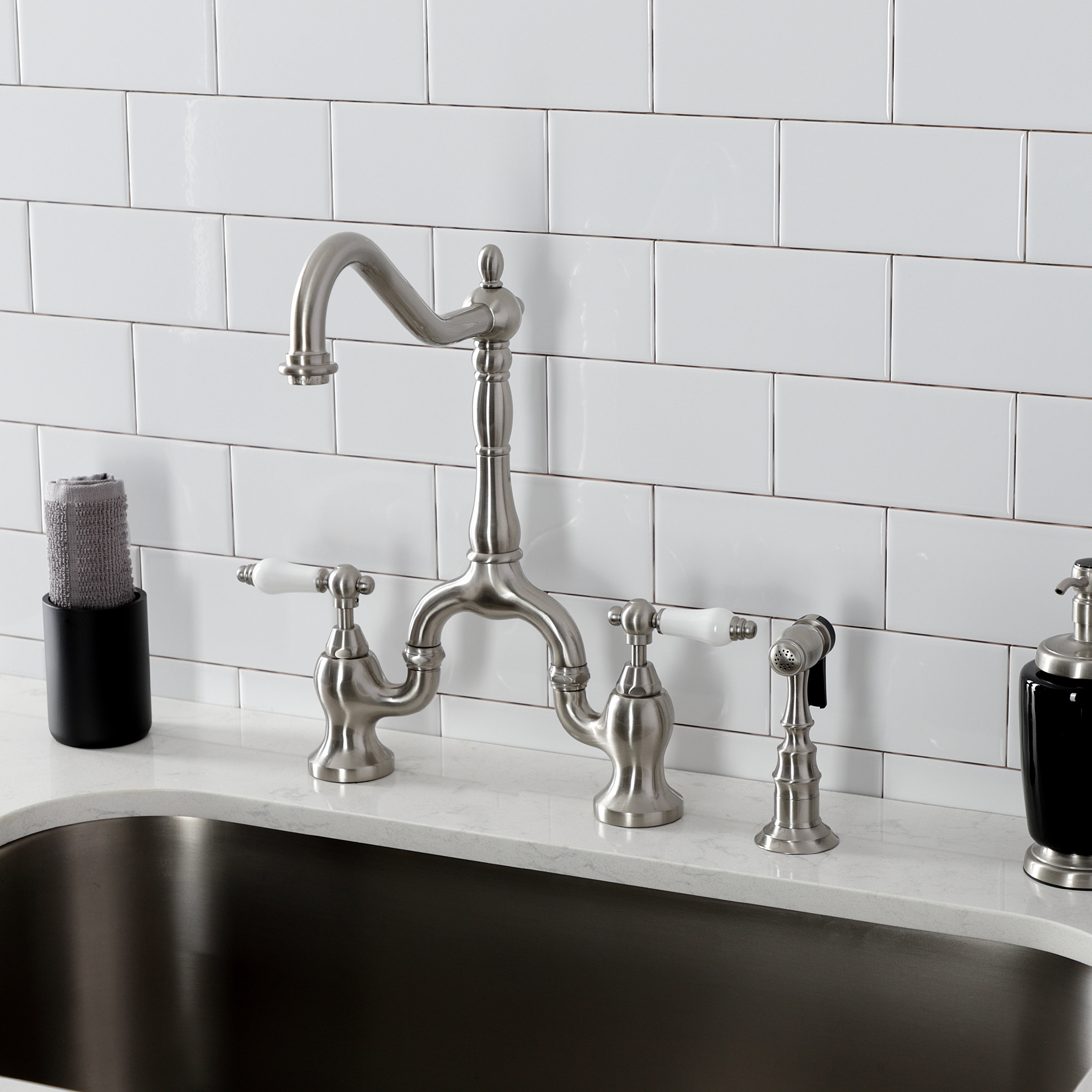 Kingston KS7753PLBS English Country Bridge Kitchen Faucet with Brass Sprayer, Antique Brass installed in kitchen.