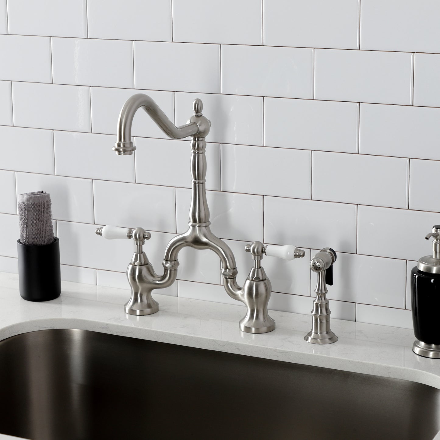 Kingston KS7753PLBS English Country Bridge Kitchen Faucet with Brass Sprayer, Antique Brass installed in kitchen.
