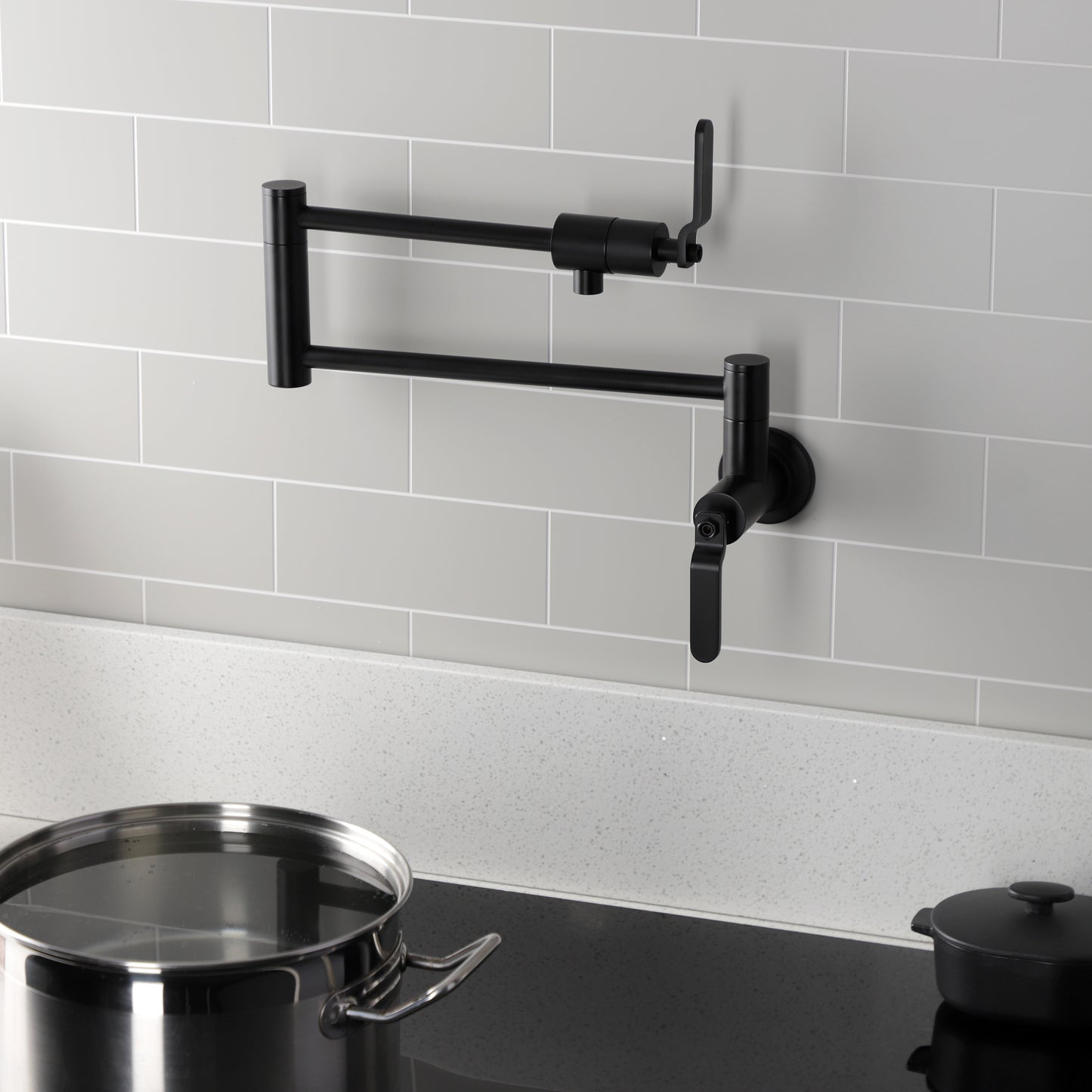 Kingston Brass KS4103KL Whitaker Wall Mount Pot Filler Faucet, Antique Brass in a modern kitchen setting.