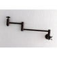 Kingston Brass KS8103ZX Millennium Wall Mount Pot Filler Faucet, Antique Brass on white tiled wall