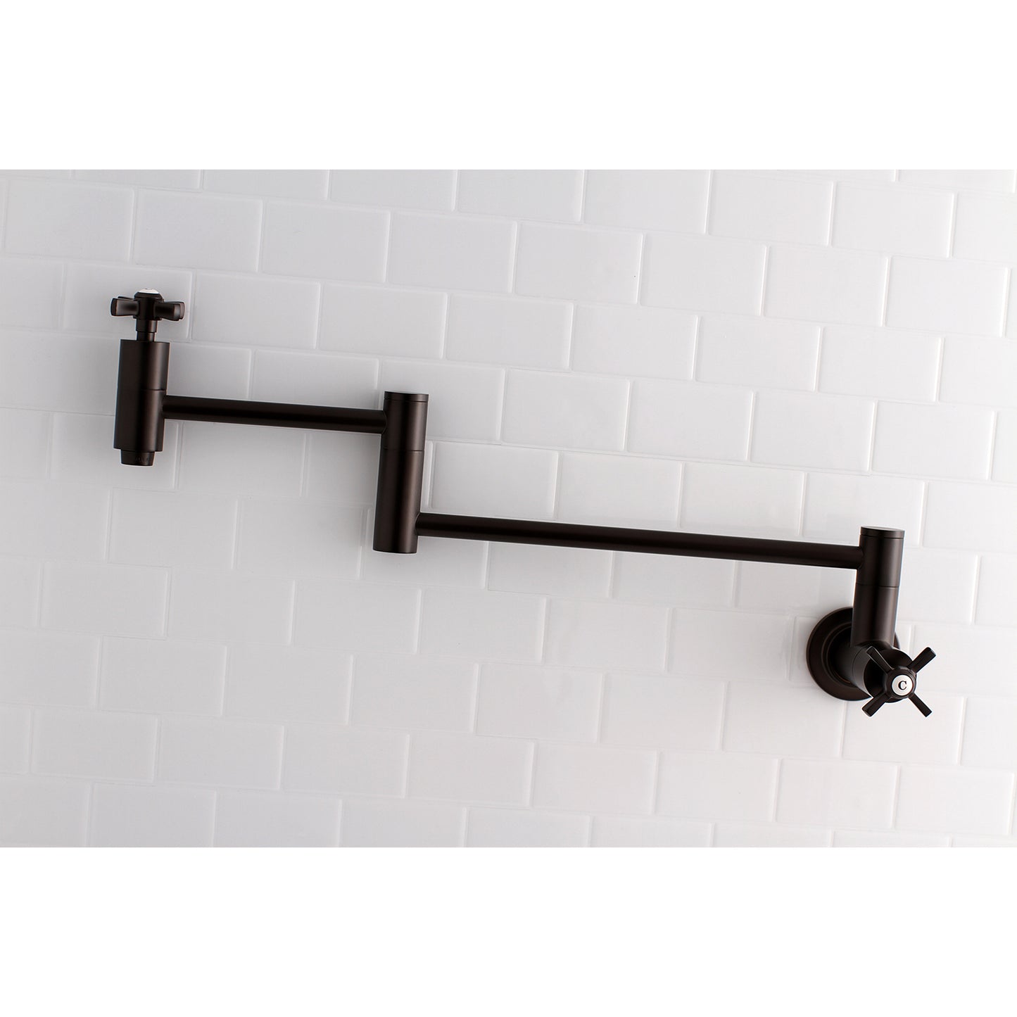 Kingston Brass KS8103ZX Millennium Wall Mount Pot Filler Faucet, Antique Brass on white tiled wall