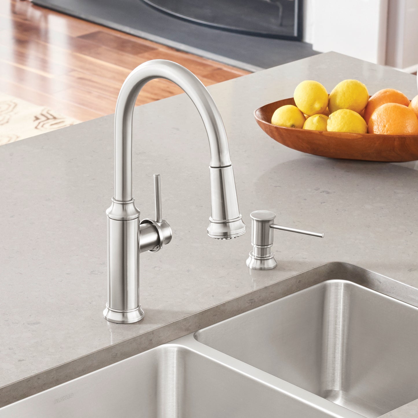 BLANCO Empressa High Arc Pull-Down Dual-Spray Kitchen Faucet in a modern kitchen with fresh fruits on the countertop.