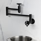 Kingston Brass KS8103CG Fuller Wall Mount Pot Filler Faucet, Antique Brass mounted, displayed with a pot
