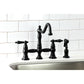 Kingston KS3277PKLBS Duchess Bridge Kitchen Faucet with Brass Sprayer, Brushed Brass on a kitchen sink.