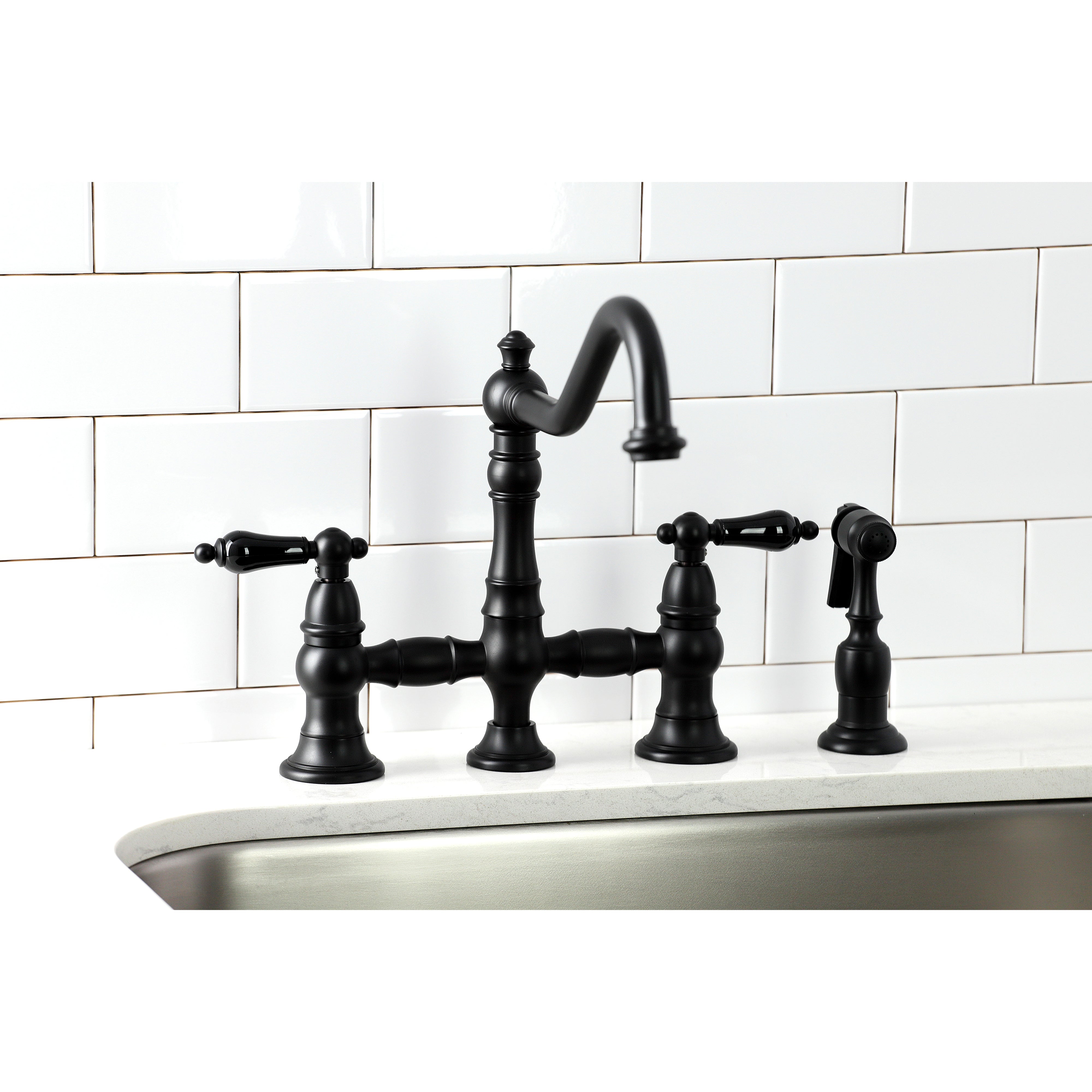 Kingston KS3277PKLBS Duchess Bridge Kitchen Faucet with Brass Sprayer, Brushed Brass on a kitchen sink.