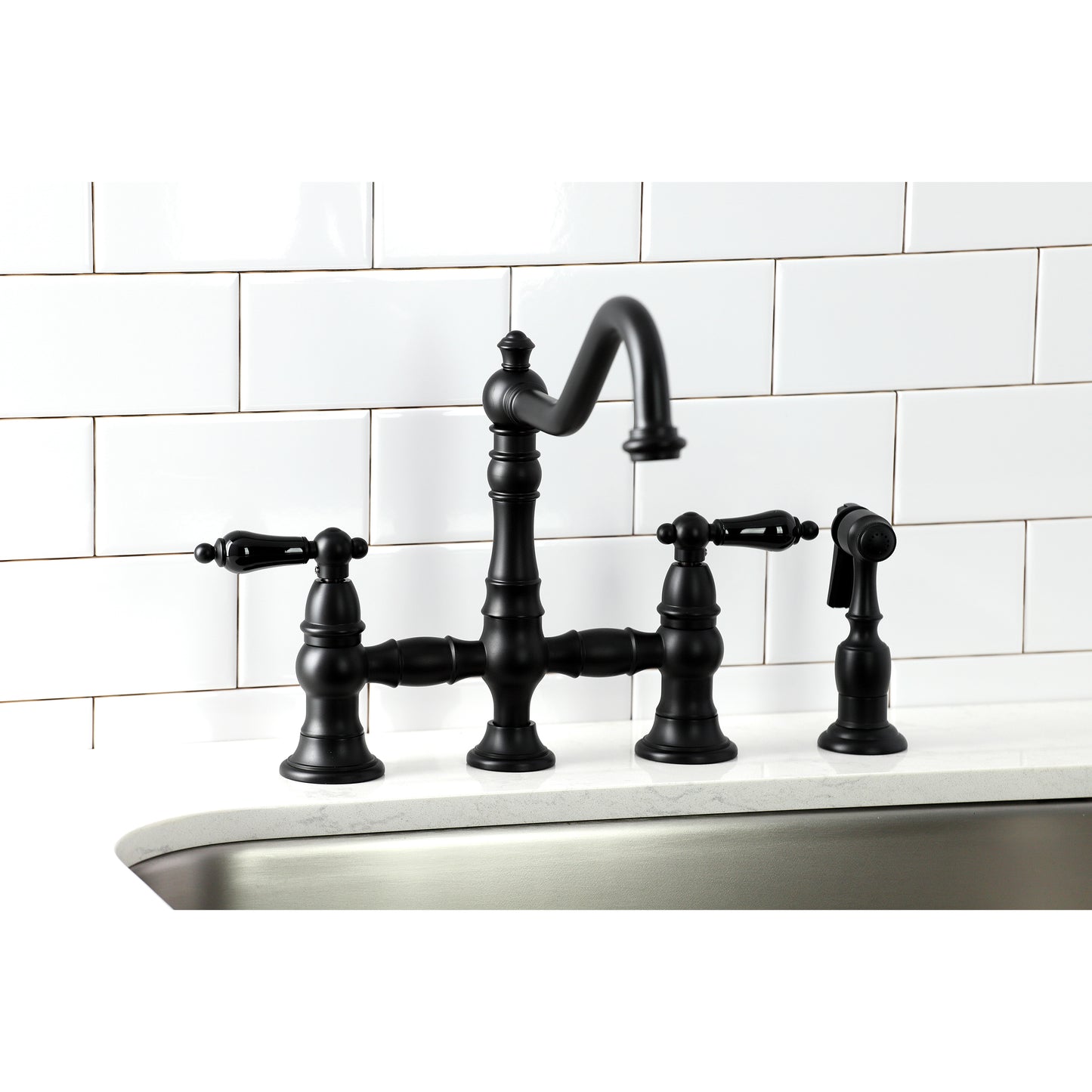 Kingston KS3277PKLBS Duchess Bridge Kitchen Faucet with Brass Sprayer, Brushed Brass on a kitchen sink.