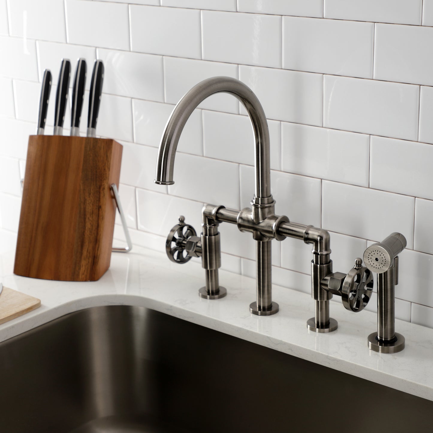 Kingston KS2333RX Belknap Industrial Style Bridge Kitchen Faucet with Brass Sprayer, Antique Brass in modern kitchen setting