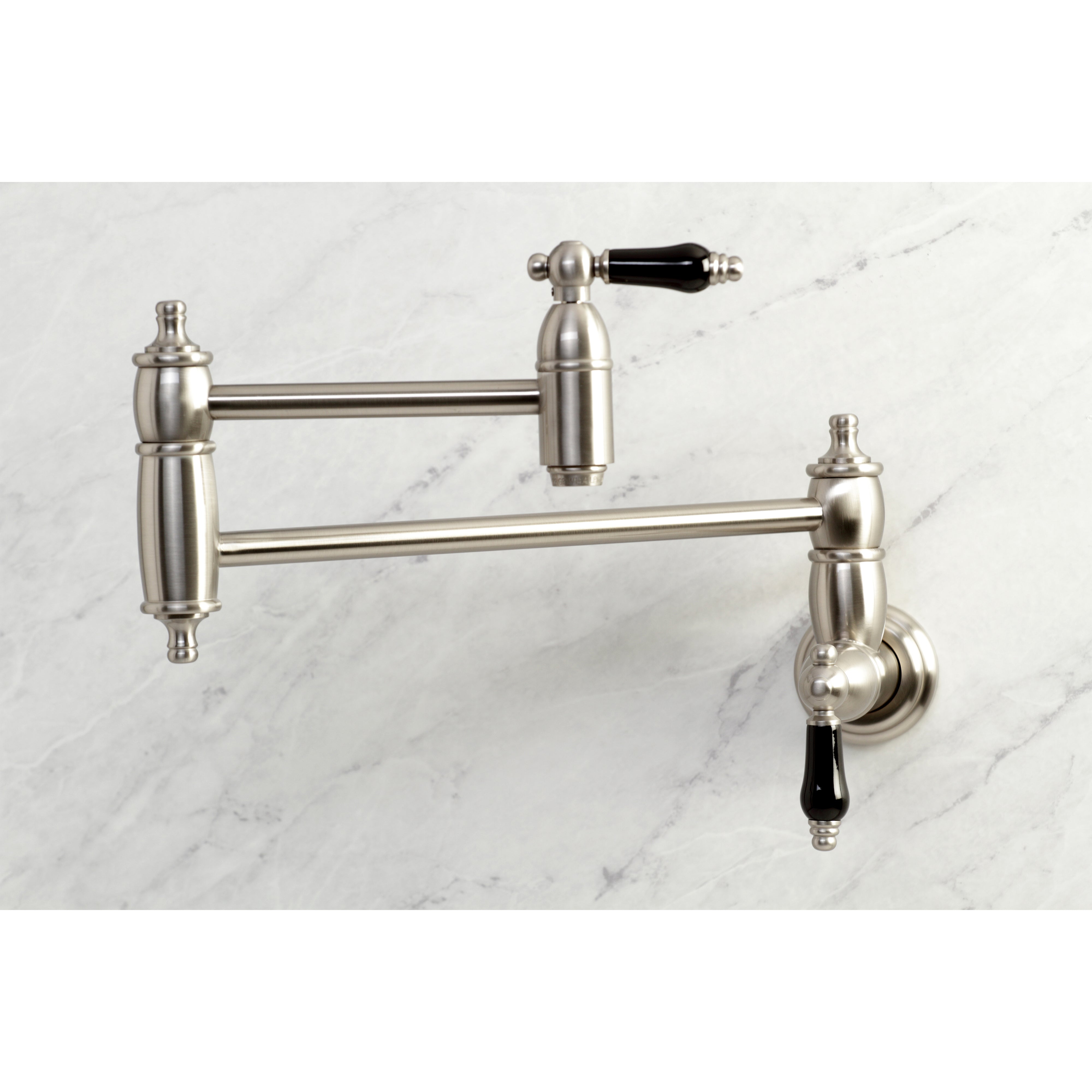 Kingston Brass KS3103PKL Duchess Wall Mount Pot Filler Faucet, Antique Brass with black porcelain handles.