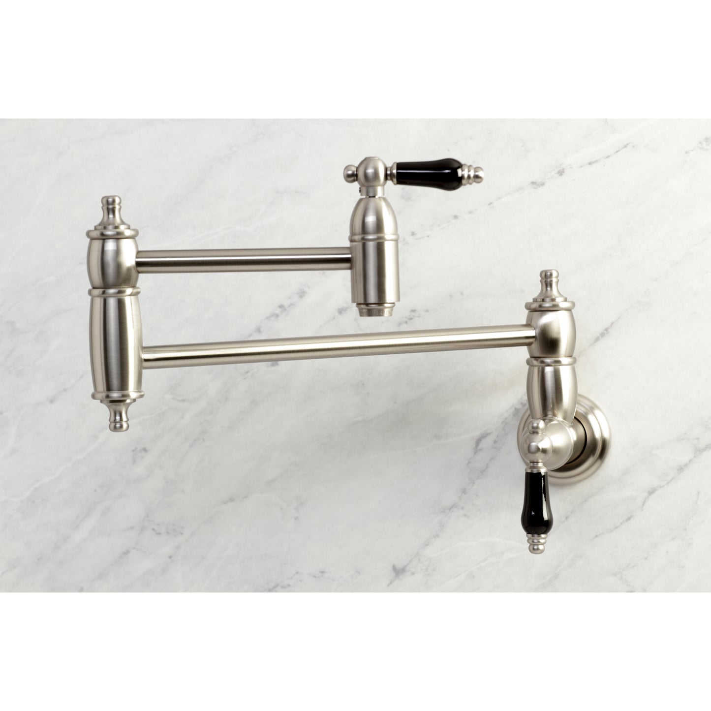 Kingston Brass KS3103PKL Duchess Wall Mount Pot Filler Faucet, Antique Brass with black porcelain handles.