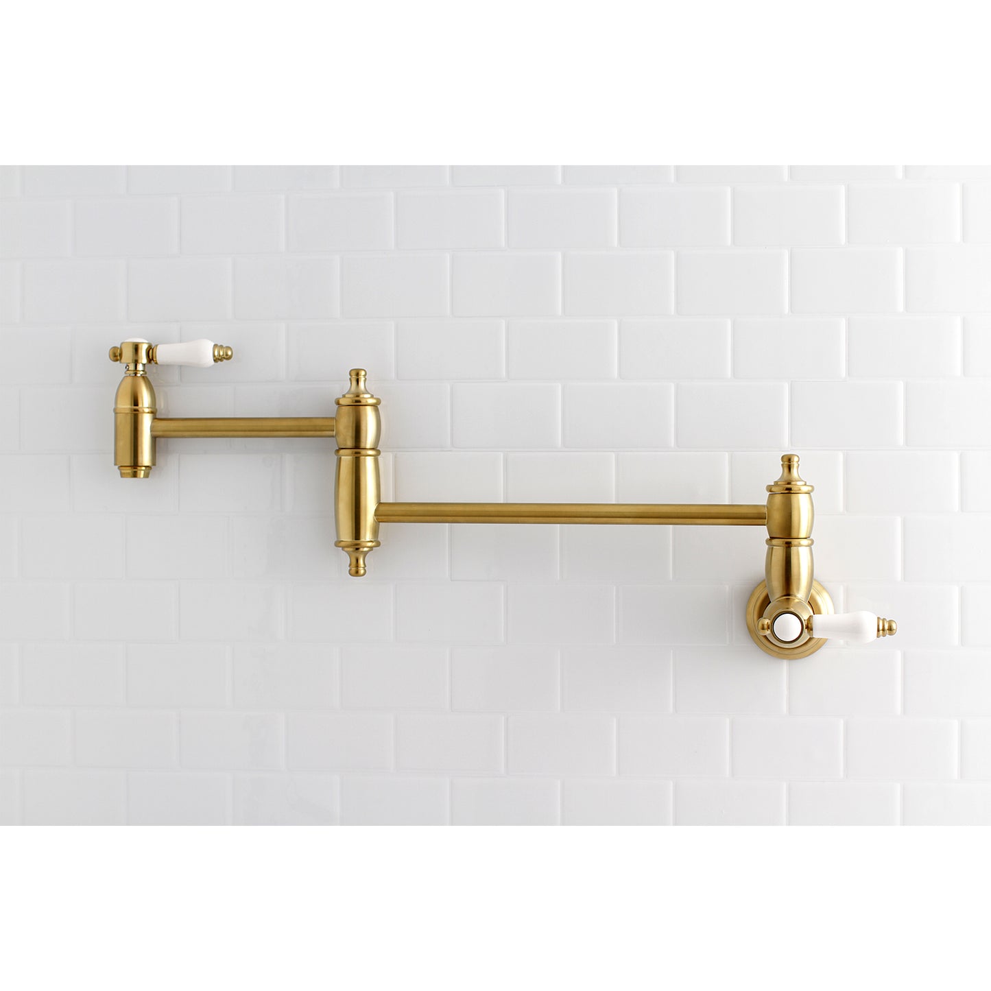 Kingston Brass KS3103BPL Bel-Air Wall Mount Pot Filler Faucet, Antique Brass on kitchen wall.
