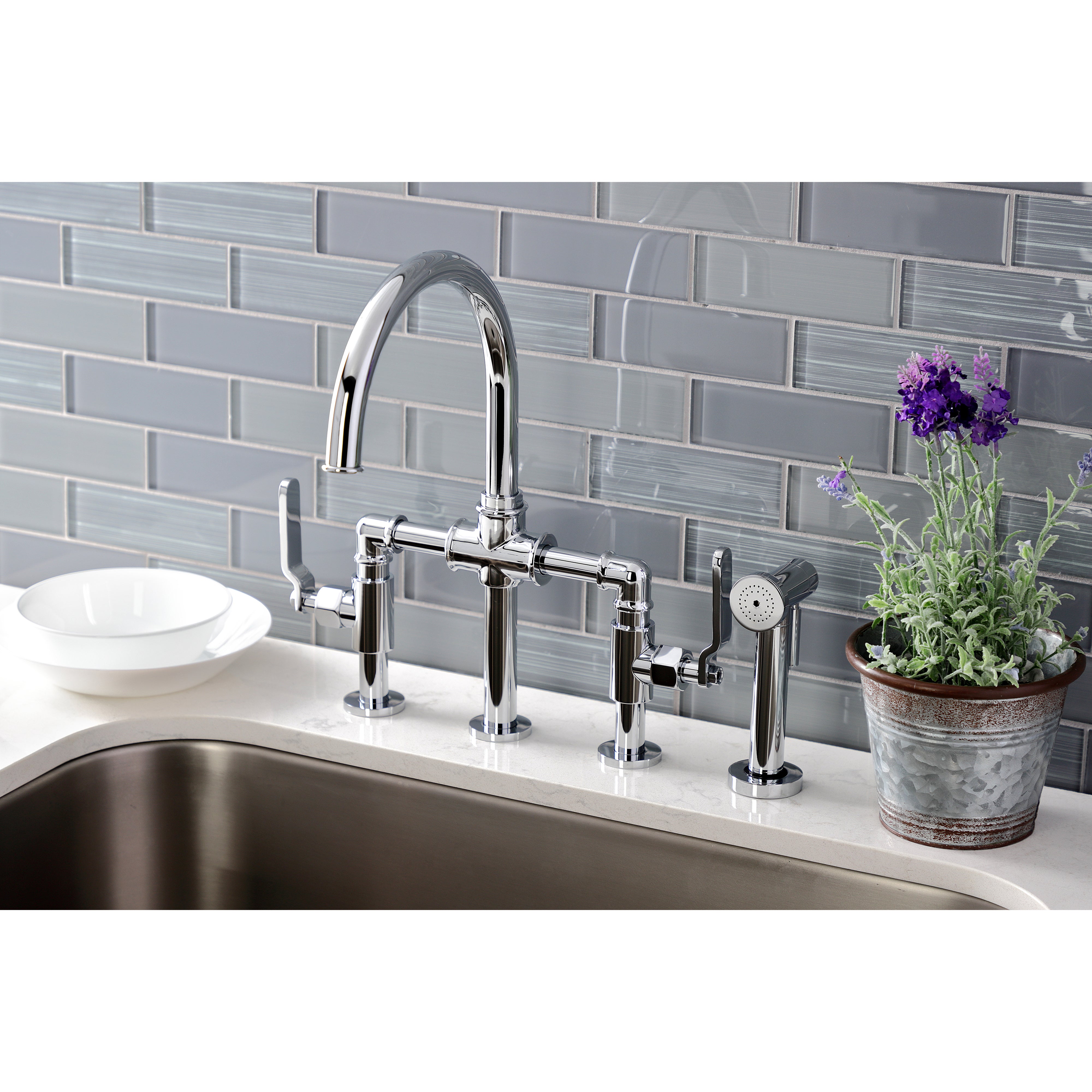 Kingston KS2333KL Whitaker Industrial Style Bridge Kitchen Faucet with Brass Sprayer, Antique Brass in a modern kitchen setting.