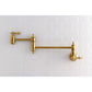 Kingston Brass KS3103AL Restoration Wall Mount Pot Filler Faucet, Antique Brass on a white tiled wall.