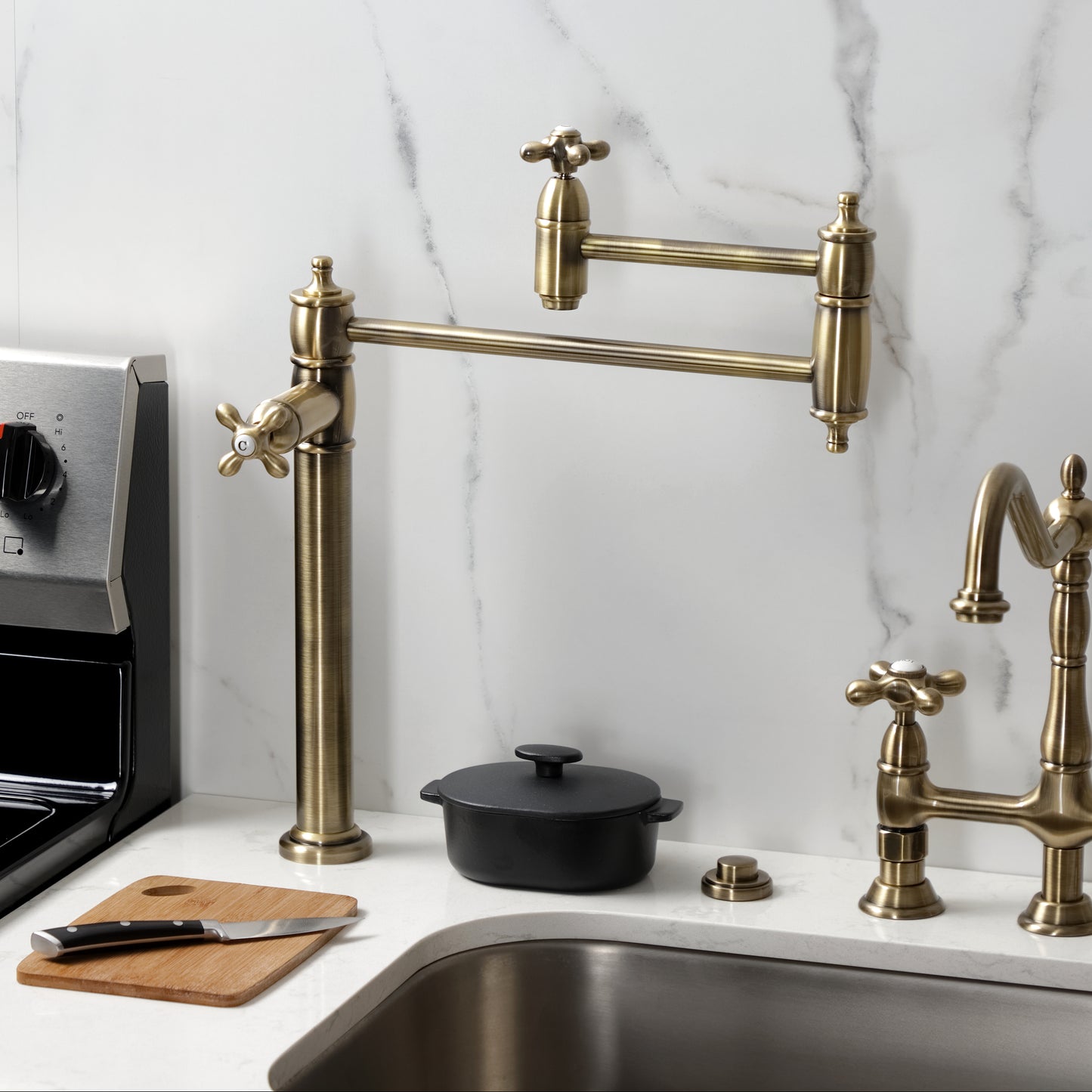Kingston Brass KS3703AX Restoration Deck Mount Pot Filler Faucet, Antique Brass on a countertop with stove.