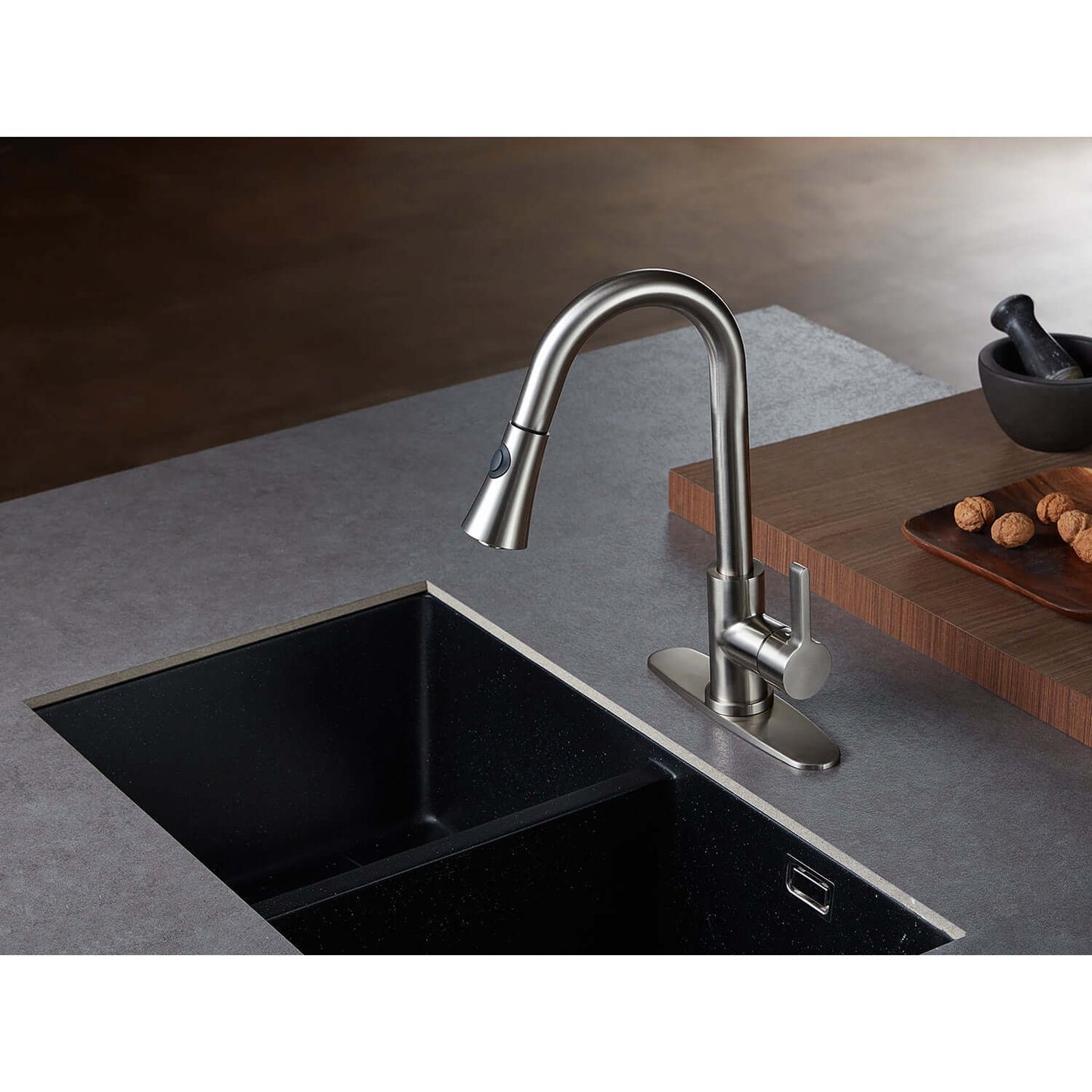 Kingston Brass LS8723CTL Continental Pull-Down Kitchen Faucet with curved spout design, top view, installed over a black sink.