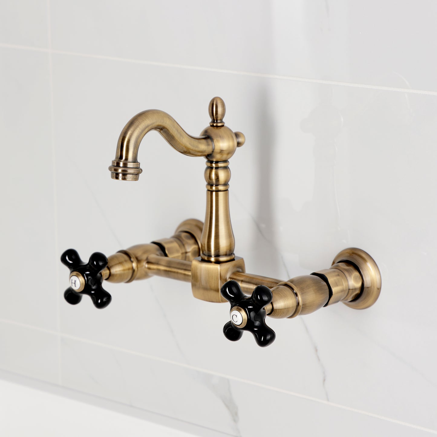 Kingston KS2443PKX Duchess Two-Handle Wall Mount Bridge Kitchen Faucet, Antique Brass with black cross handles