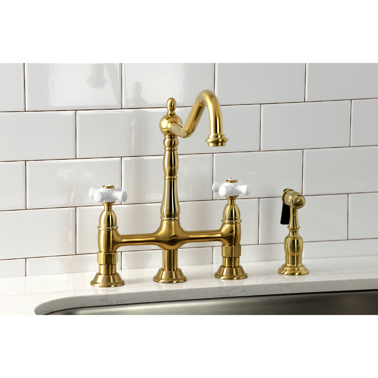 Kingston Brass Heritage Bridge Kitchen Faucet with Brass Sprayer and Cross Handles in satin gold finish.