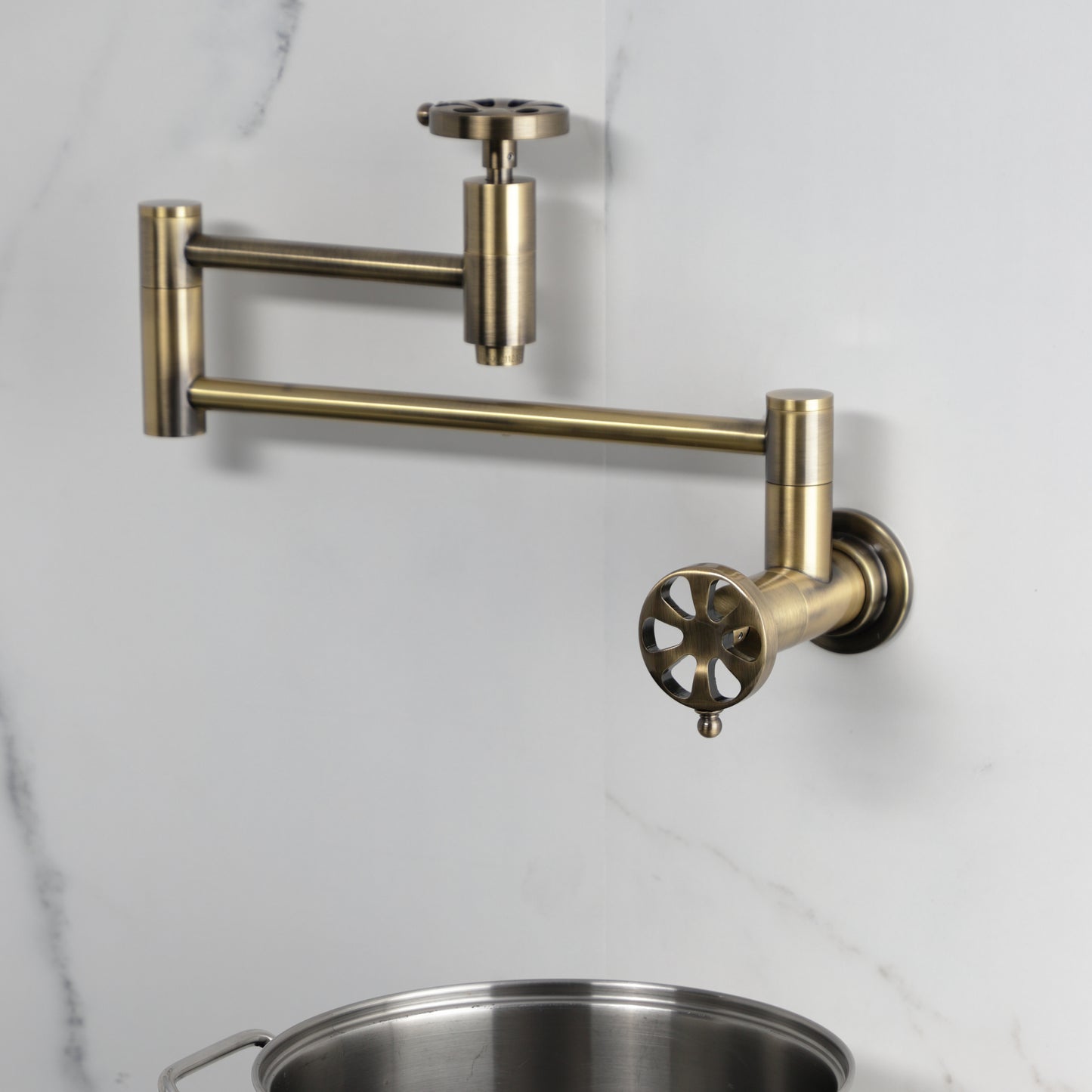 Kingston Brass KS8103RX Belknap Wall Mount Pot Filler Faucet, Antique Brass with foldable swing arms and traditional design.