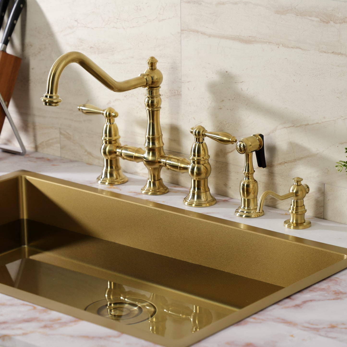 Kingston KS3277ALBS Restoration Bridge Kitchen Faucet with Brass Sprayer, Brushed Brass installed in a modern kitchen setup.