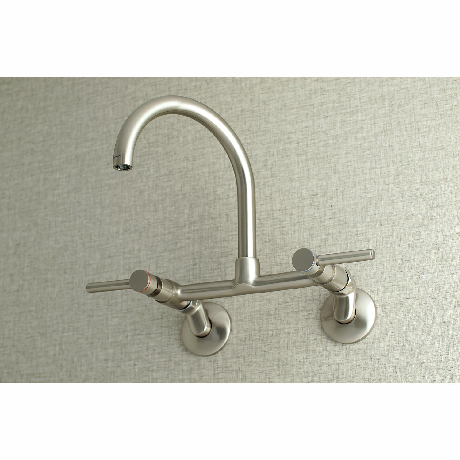 Kingston Brass KS814SB Concord Wall Mount Bridge Kitchen Faucet in a sleek stainless steel finish.