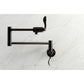 Kingston Brass KS4103DFL NuWave Wall Mount Pot Filler Faucet, Antique Brass on a marble background.