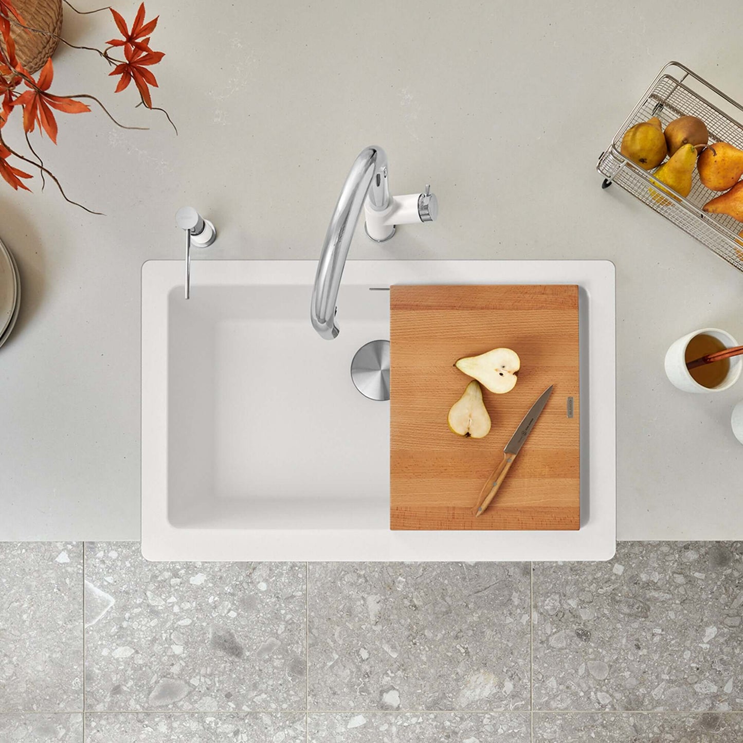 BLANCO VINTERA 30" SILGRANIT Single Bowl Farmhouse Sink with cutting board and knife beside halved pears.