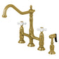 Kingston Brass Heritage Bridge Kitchen Faucet with Brass Sprayer and Cross Handles in Brushed Brass finish.
