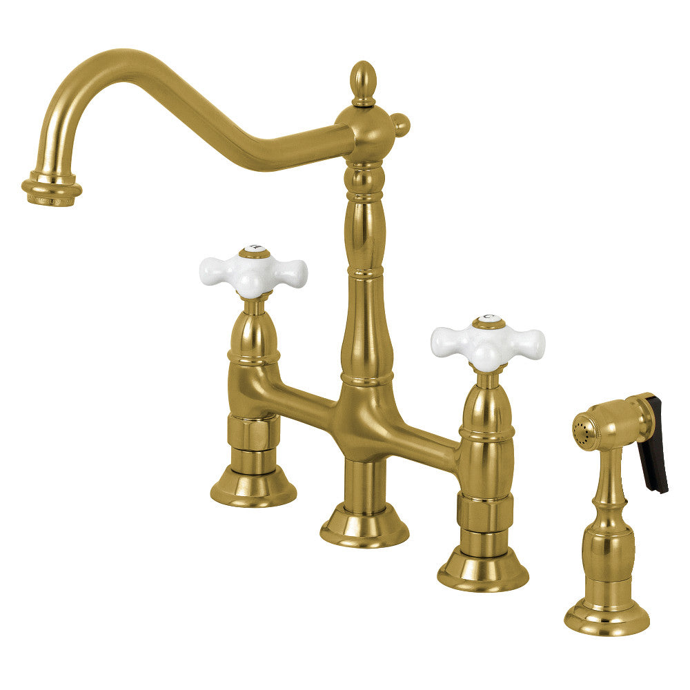 Kingston Brass Heritage Bridge Kitchen Faucet with Brass Sprayer and Cross Handles in Brushed Brass finish.