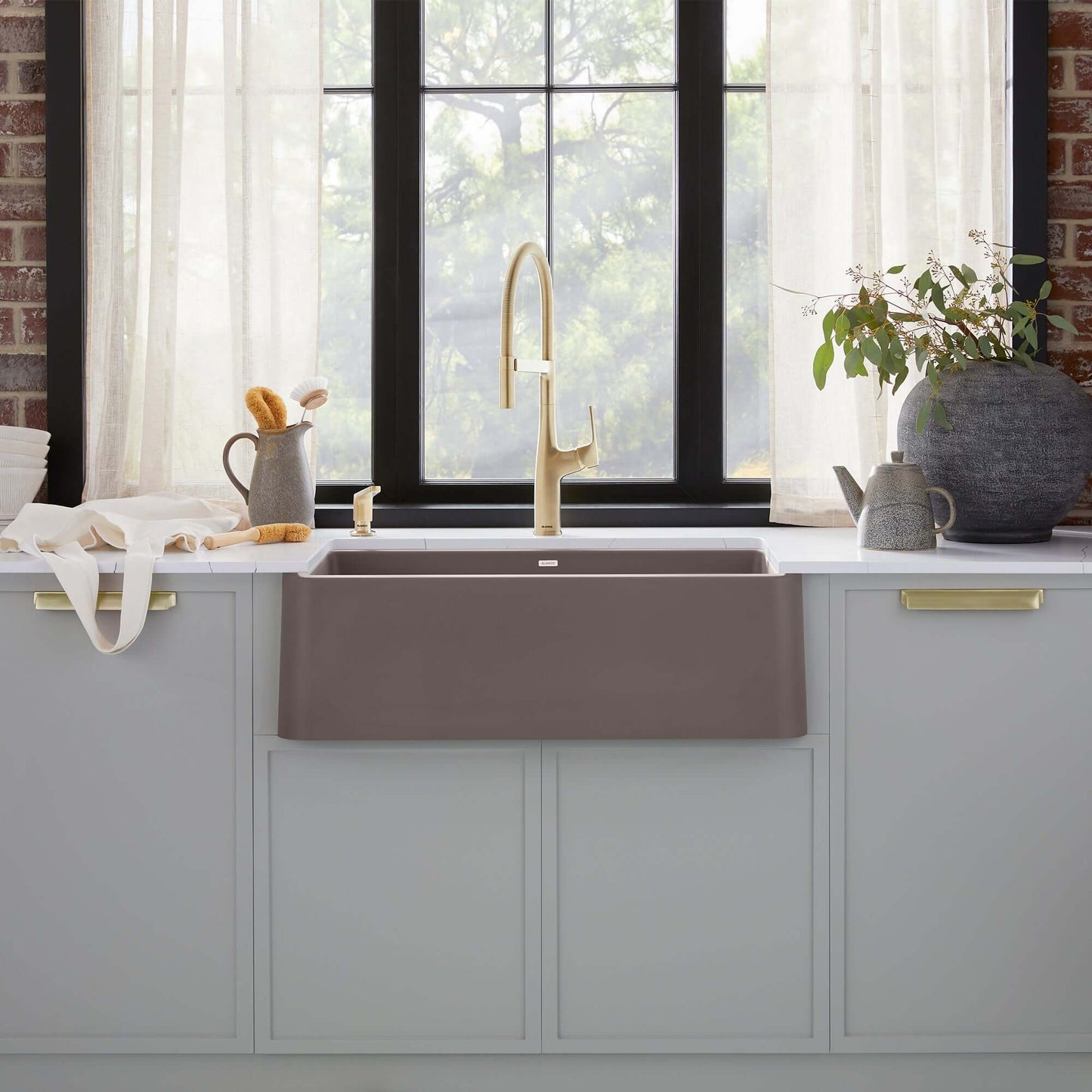 BLANCO Ikon SILGRANIT 33" Single Bowl Apron-Front Farmhouse Sink in a modern kitchen setting with natural lighting.