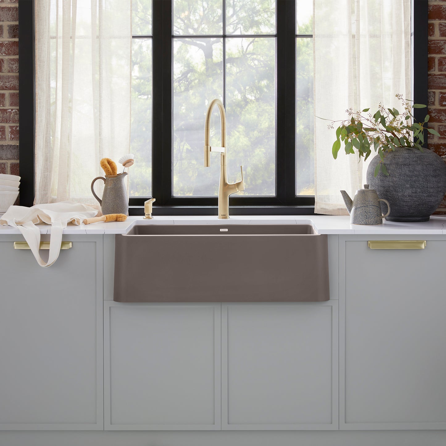 BLANCO Ikon SILGRANIT 30" Single Bowl Apron-Front Farmhouse Sink displayed in a stylish kitchen setting with a faucet.