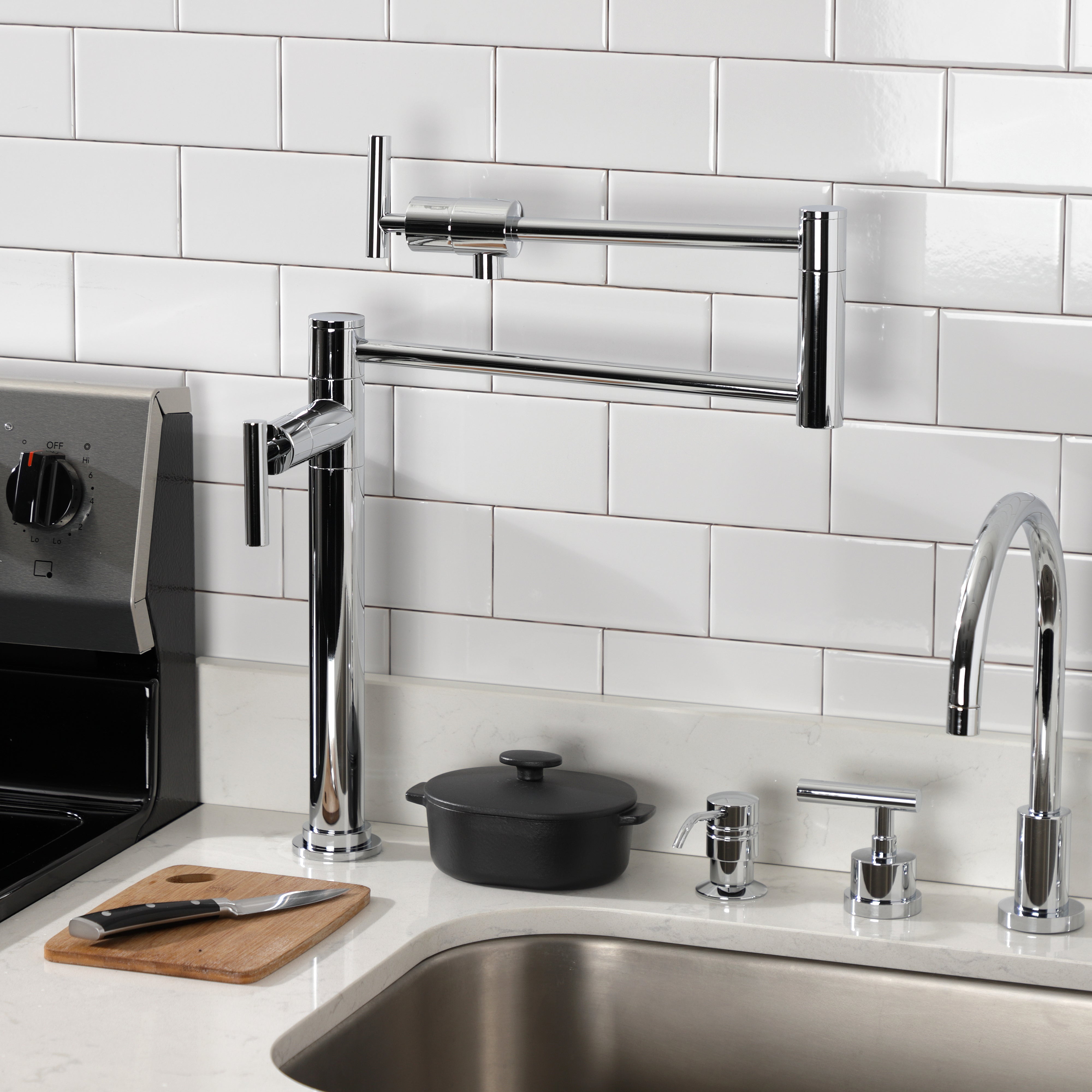 Kingston Brass KS4703CML Manhattan Deck Mount Pot Filler Faucet, Antique Brass in a modern kitchen setup.