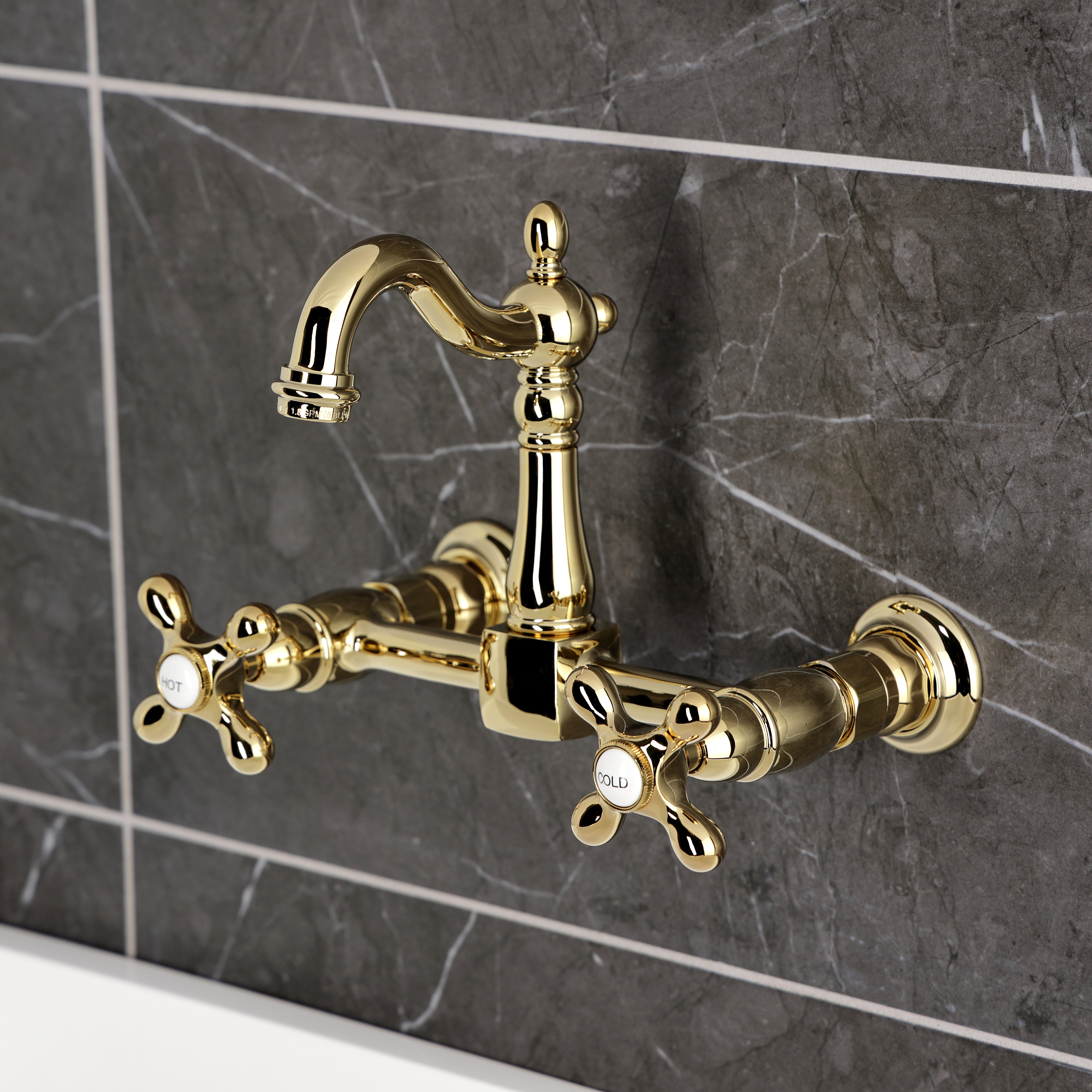 Kingston KS2443AX Heritage Two-Handle Wall Mount Bridge Kitchen Faucet, Antique Brass in a luxurious gold finish