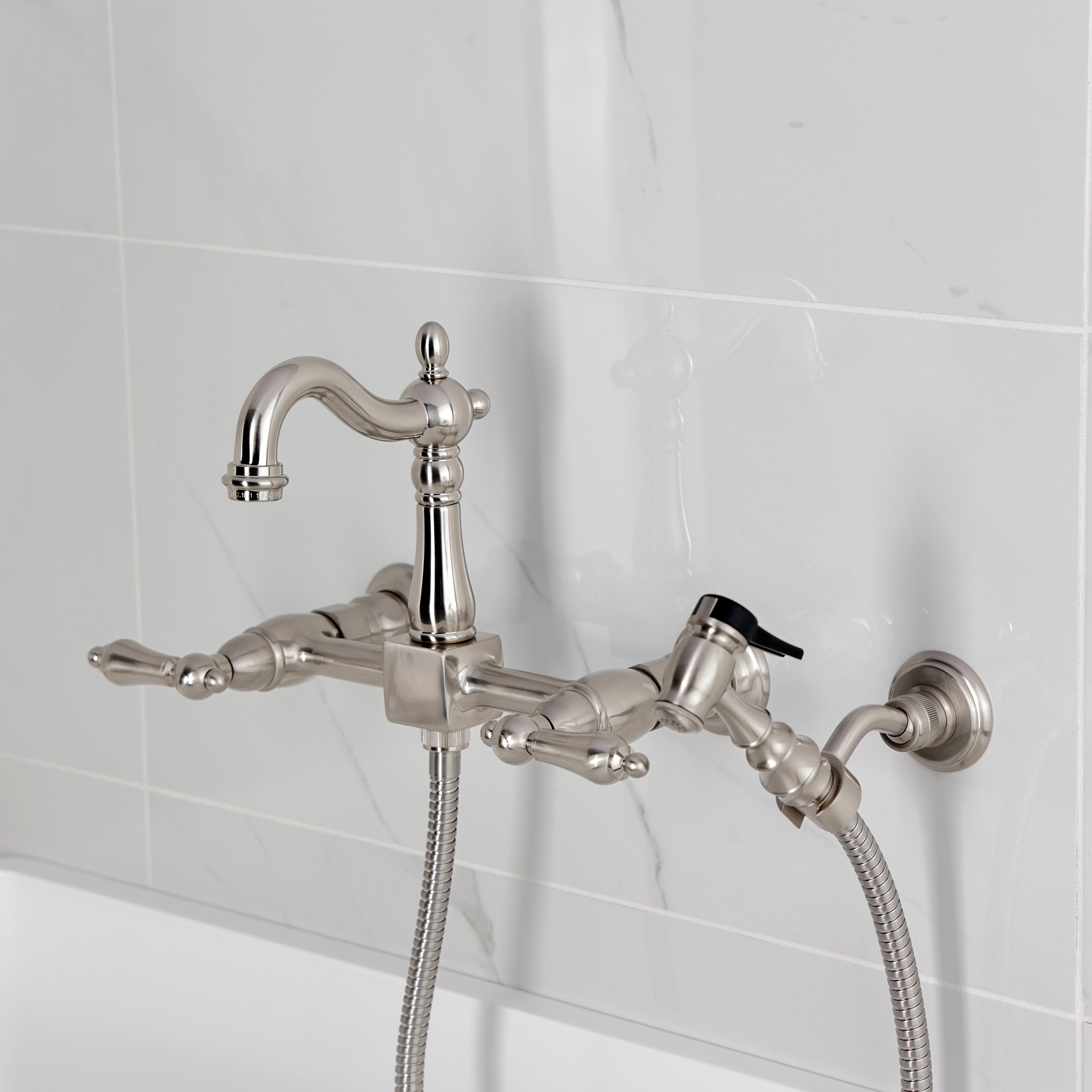 Kingston KS2443ALBS Heritage Two-Handle Wall Mount Bridge Kitchen Faucet with Brass Sprayer, Antique Brass in a sleek design.
