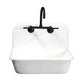 Kingston Brass KS814SB Concord Wall Mount Bridge Kitchen Faucet mounted on a white sink.
