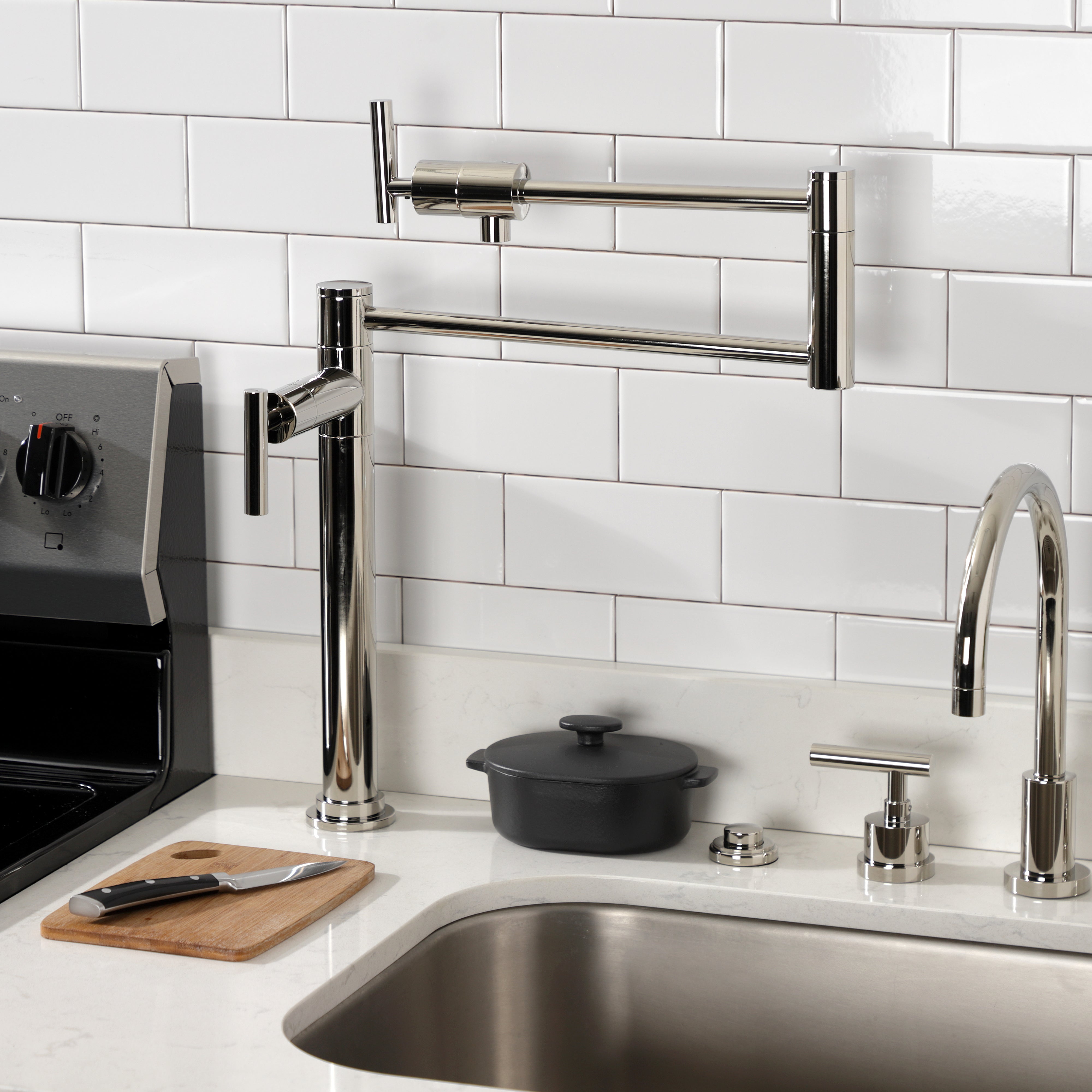 Kingston Brass KS4703CML Manhattan Deck Mount Pot Filler Faucet, Antique Brass countertop installation with modern kitchen decor.