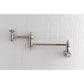Kingston Brass KS3103AX Restoration Wall Mount Pot Filler Faucet, Antique Brass on tiled wall background.