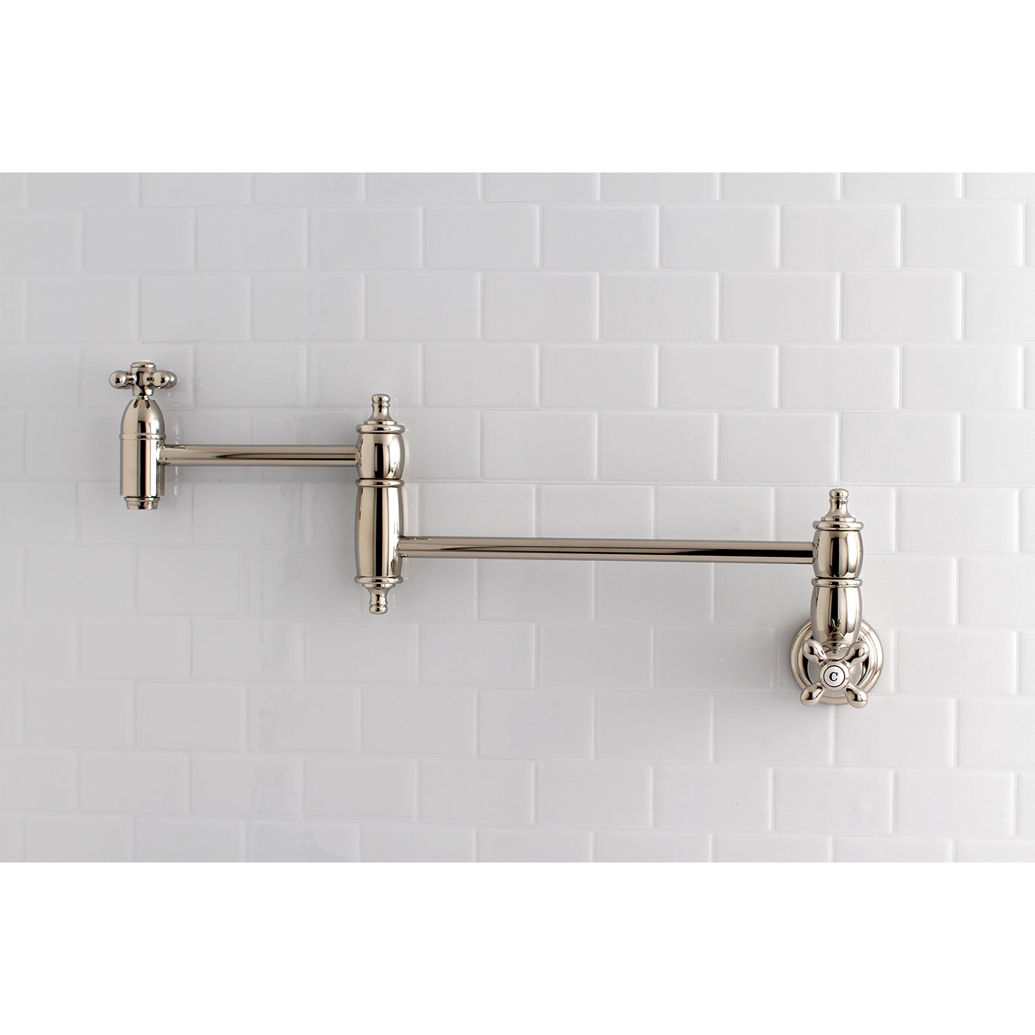 Kingston Brass KS3103AX Restoration Wall Mount Pot Filler Faucet, Antique Brass on tiled wall background.