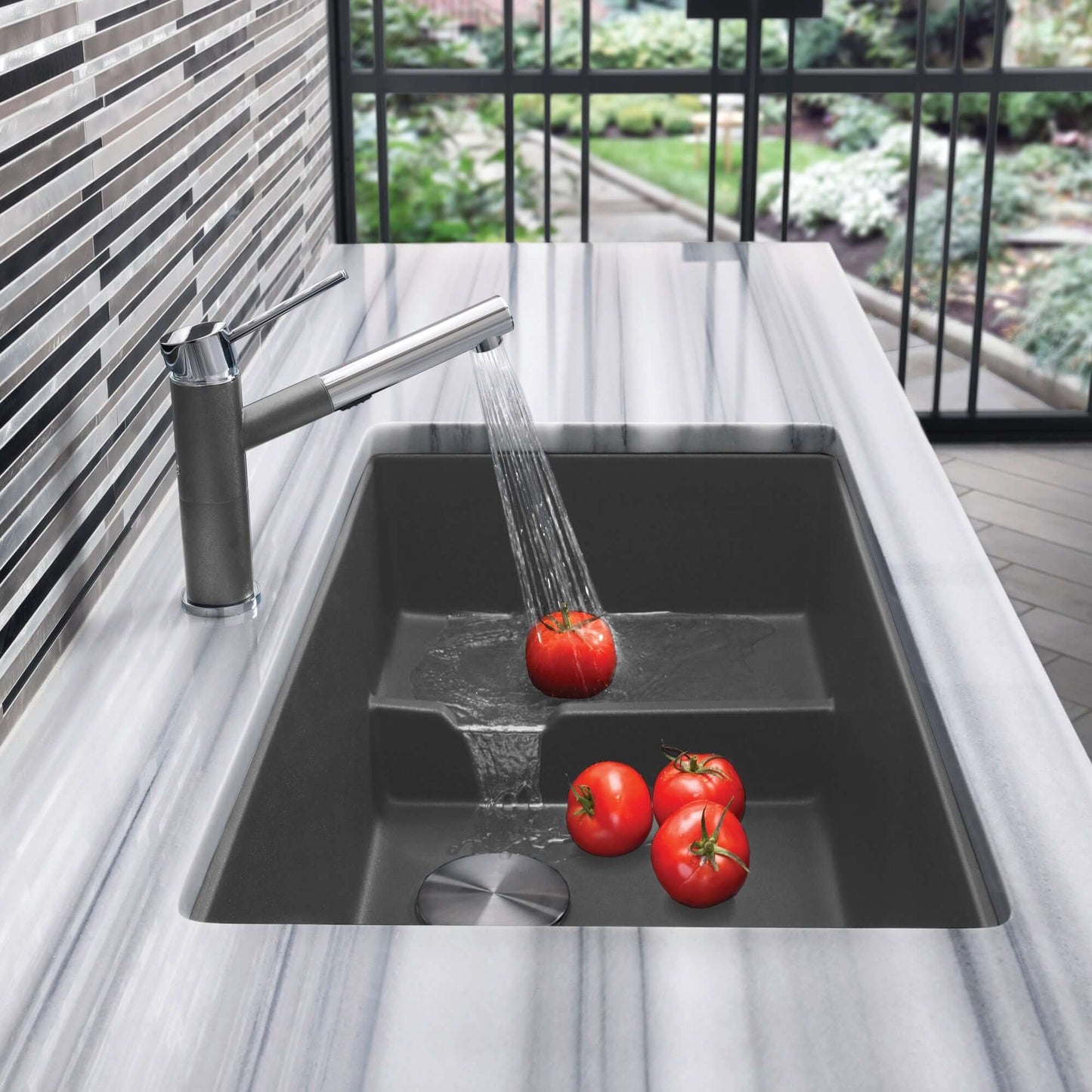 BLANCO Precis Cascade SILGRANIT 29" Single Bowl Undermount Kitchen Sink with Colander featuring fresh tomatoes.