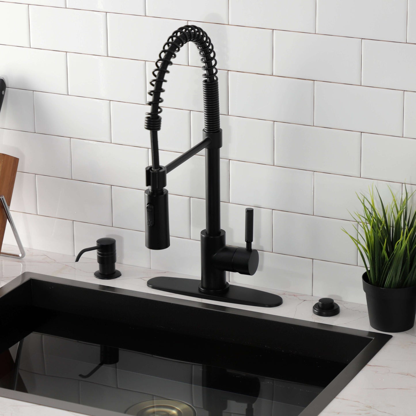 Contemporary angle of Kingston Brass LS8773DKL Kaiser Pre-Rinse Kitchen Faucet with coiled spout and ergonomic handle.