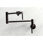 Kingston Brass KS4103DL Concord Wall Mount Pot Filler Faucet, Antique Brass on a marble background.