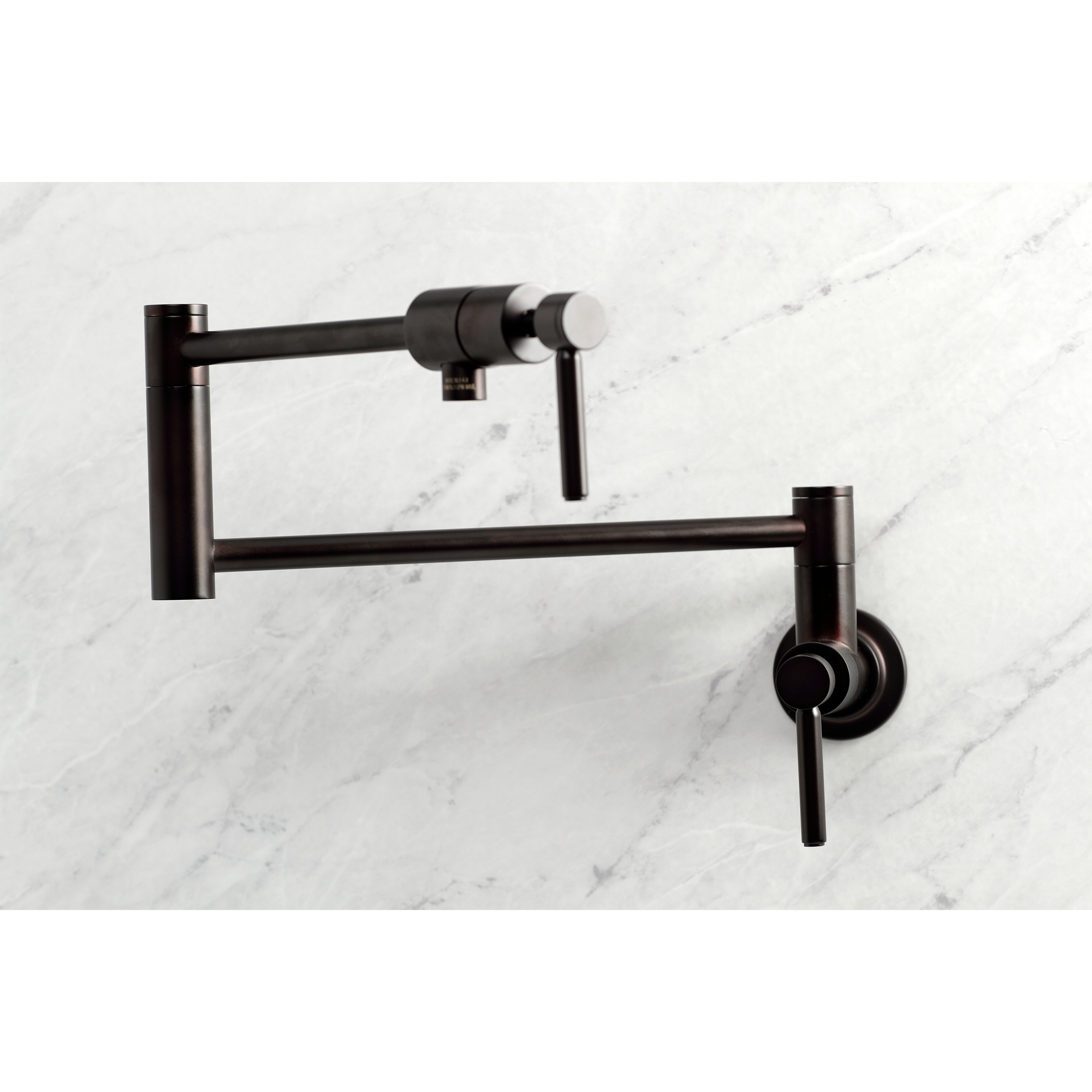 Kingston Brass KS4103DL Concord Wall Mount Pot Filler Faucet, Antique Brass on a marble background.
