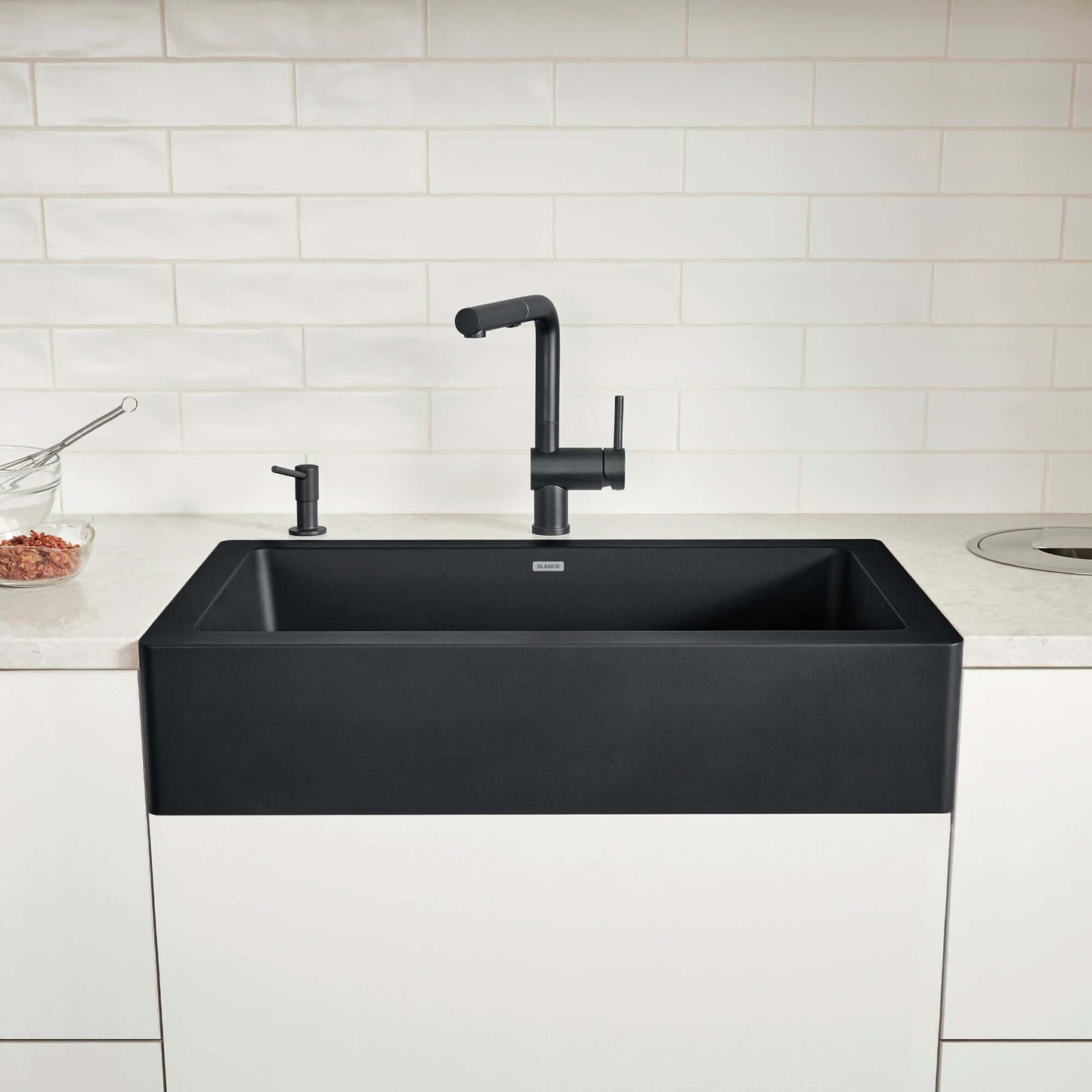 BLANCO VINTERA 30" SILGRANIT Single Bowl Farmhouse Sink with a modern black faucet in a contemporary kitchen.
