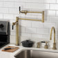 Kingston Brass KS4703CKL Kaiser Deck Mount Pot Filler Faucet, Antique Brass installed in kitchen.