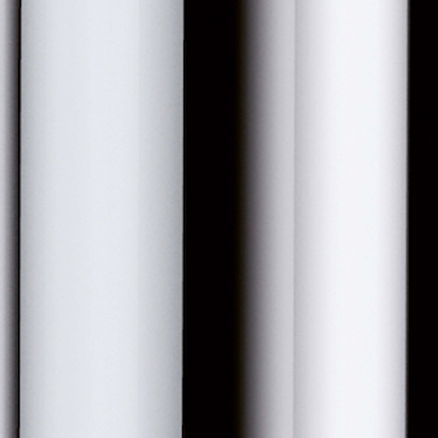 Close-up of white vertical columns with shadows contrasting against a black background.