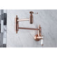 Kingston Brass KS3103BPL Bel-Air Wall Mount Pot Filler Faucet, Antique Brass on marble background