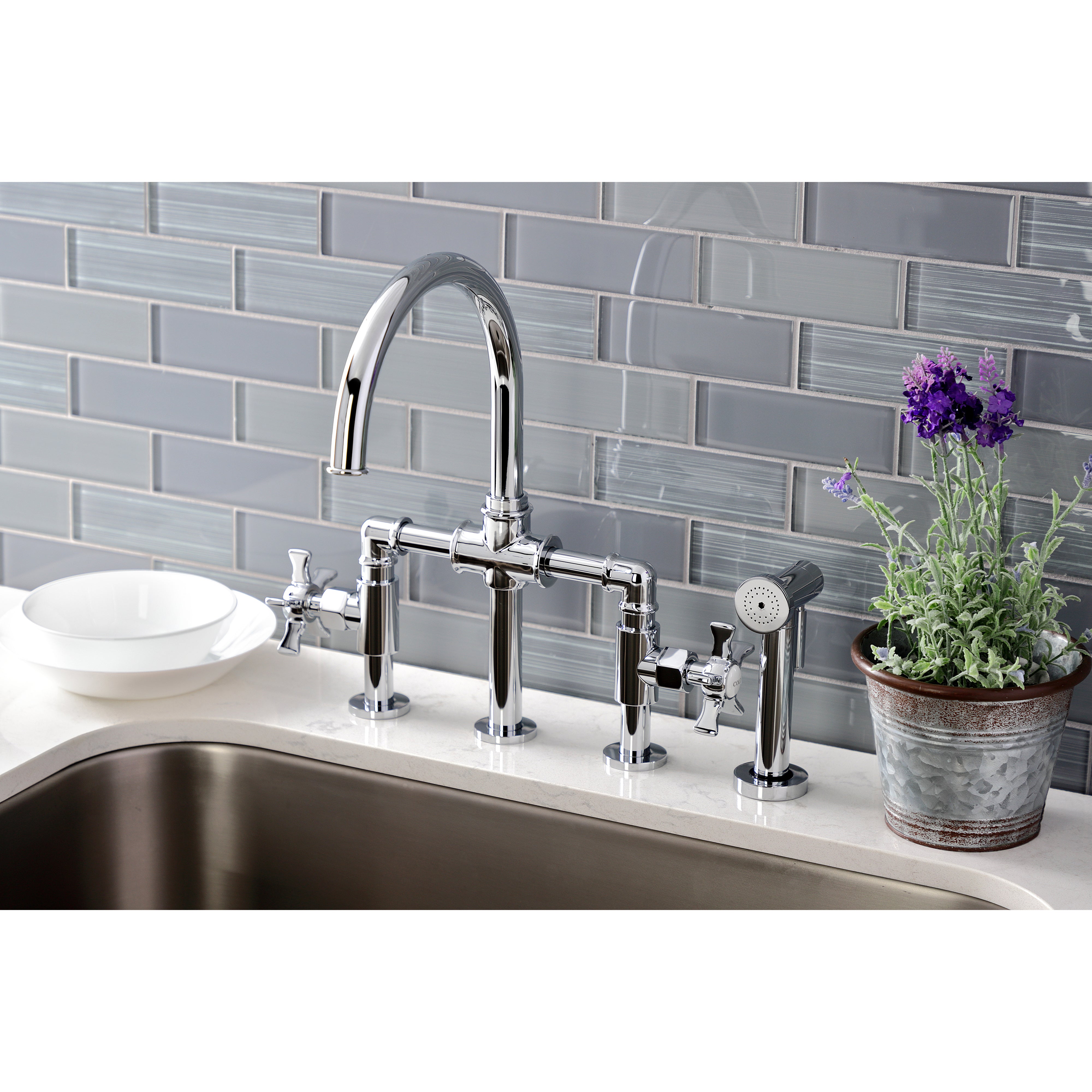 Kingston KS2333NX Hamilton Industrial Style Bridge Kitchen Faucet with Brass Sprayer, Antique Brass in a modern kitchen setting.