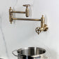 Kingston Brass KS3103RKZ Wendell Wall Mount Pot Filler Faucet with Knurled Handle, Antique Brass on wall