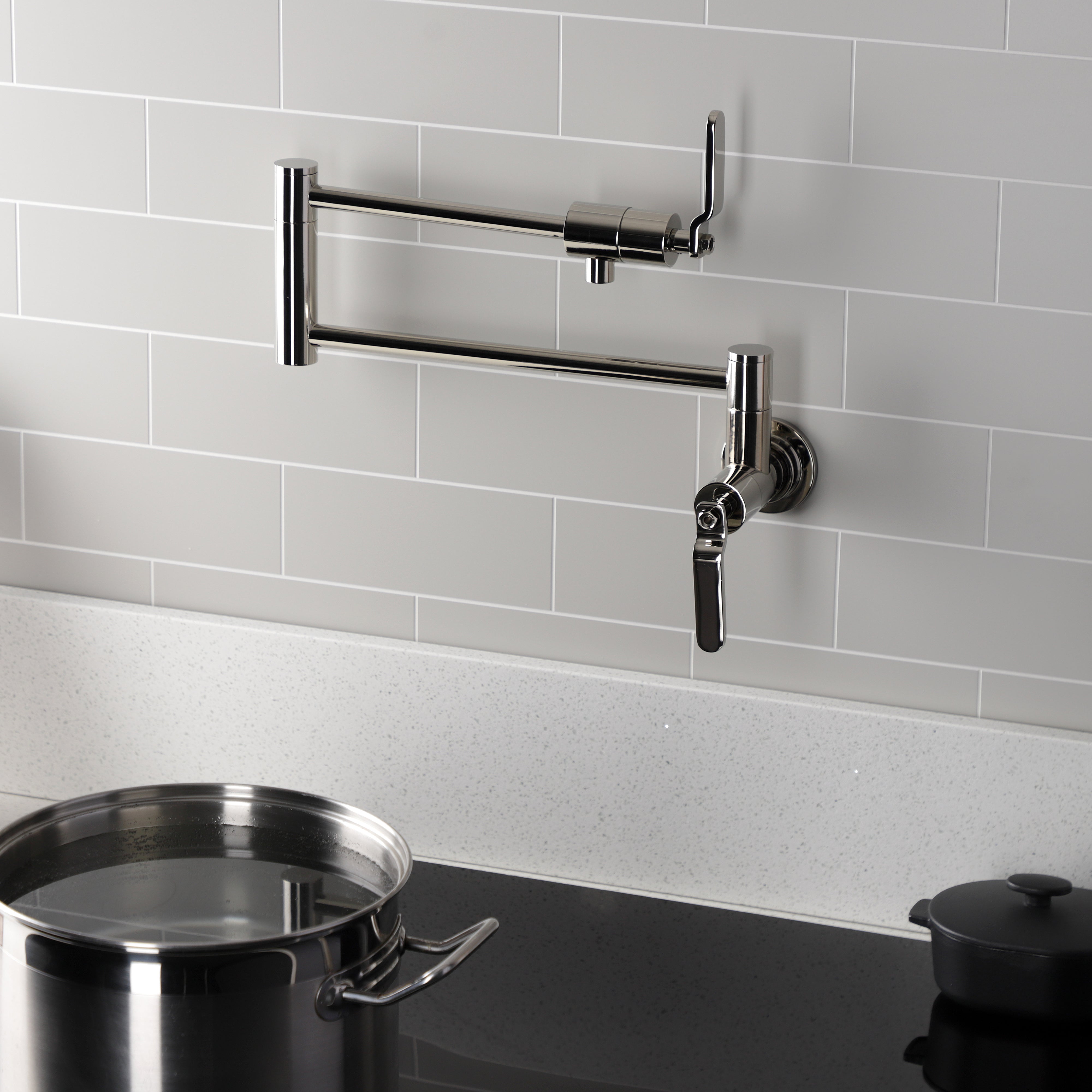 Kingston Brass KS4103KL Whitaker Wall Mount Pot Filler Faucet, Antique Brass with foldable swing arms in kitchen.