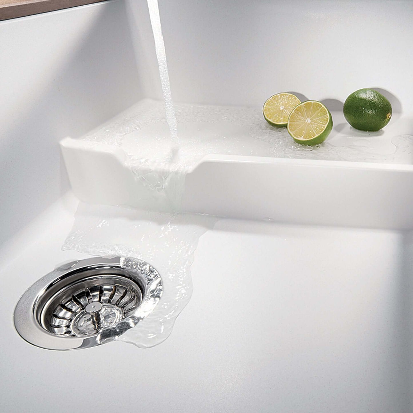 Water flowing over the integrated cascade level of the BLANCO Precis Cascade SILGRANIT 29" Single Bowl Undermount Kitchen Sink with Colander.